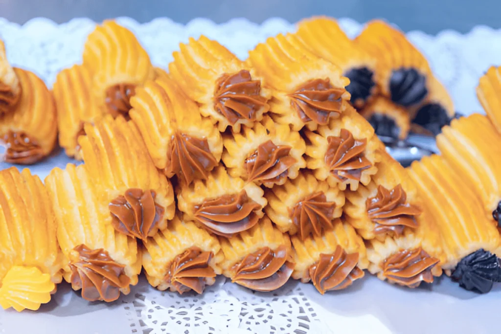 Close-up image of churros filled with dulce de leche and chocolate, showcasing the rich, creamy fillings inside crispy churro shells.