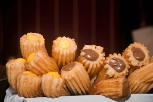 Close-up image of churros filled with dulce de leche and chocolate, showcasing the rich, creamy fillings inside crispy churro shells.